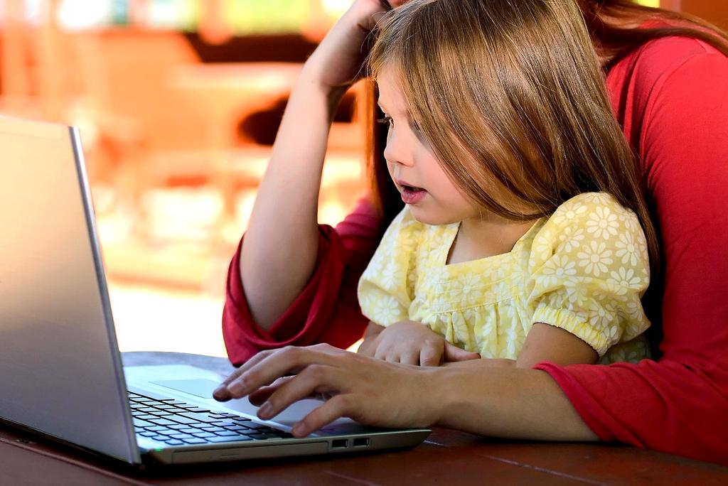 Family reviewing monthly budget with calculator and notes